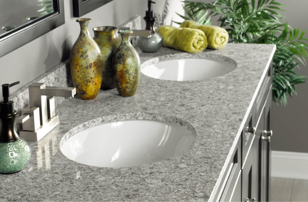 A modern bathroom vanity with a Rynone gray granite countertop, part of their updated marketing collateral.