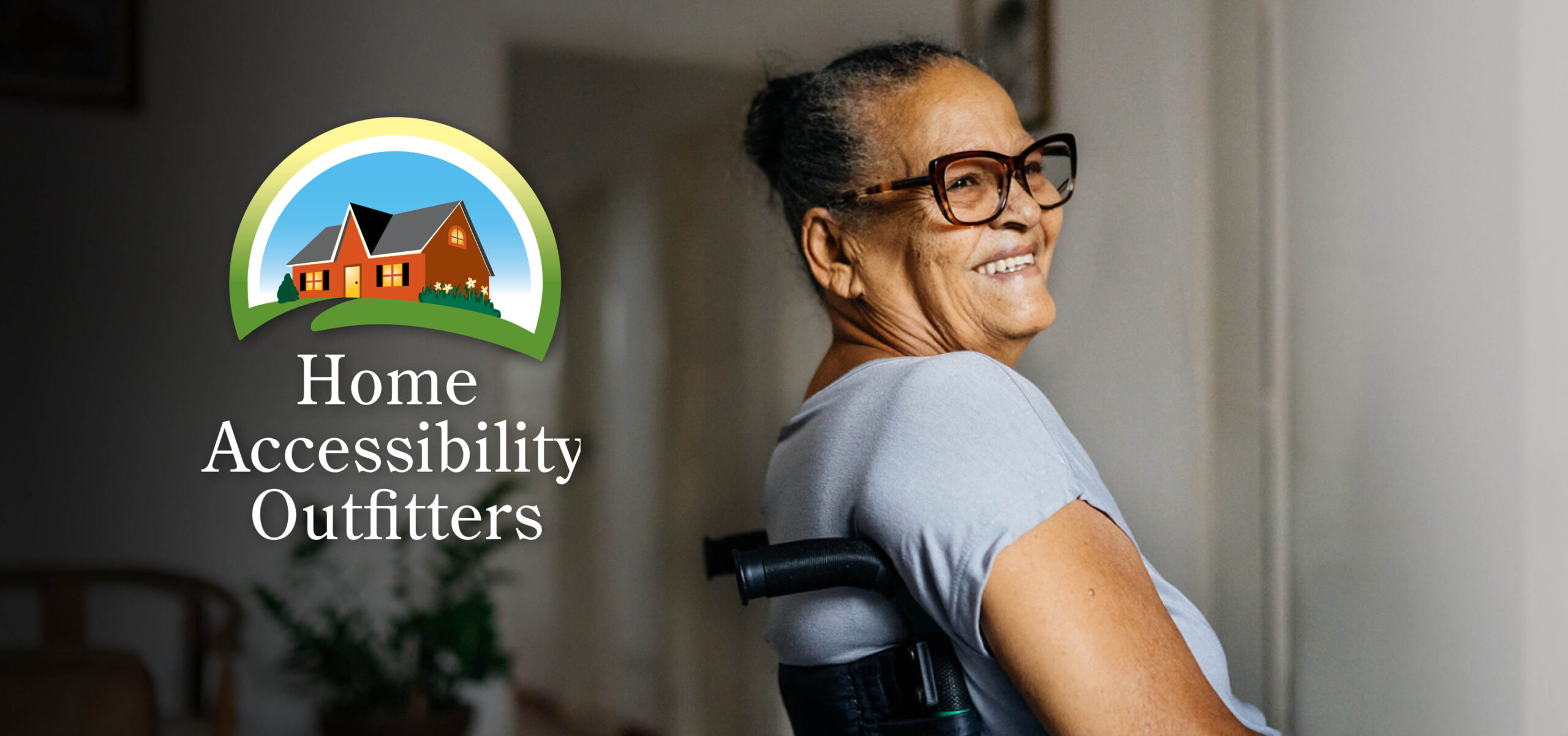 A smiling elderly woman in a wheelchair at home, with the Home Accessibility Outfitters logo displayed beside her.